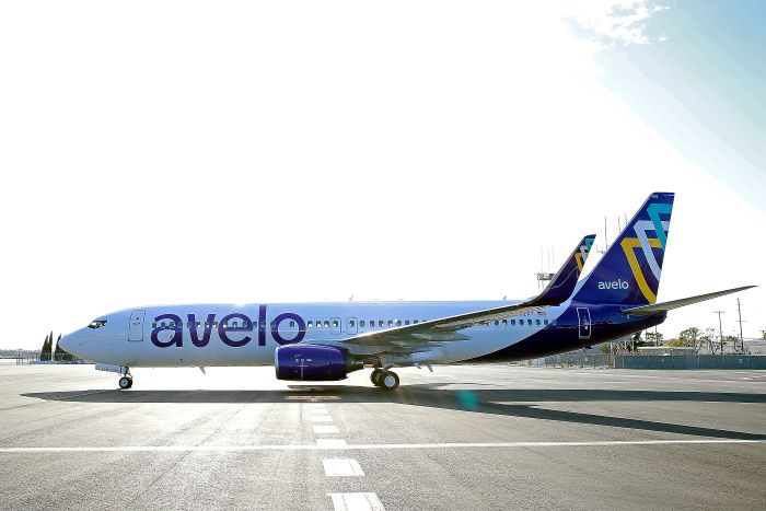 photo of an Avelo plane on the runway of an airport. 